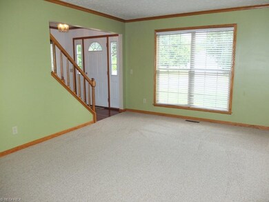 Formal living room with crown molding and new carp
