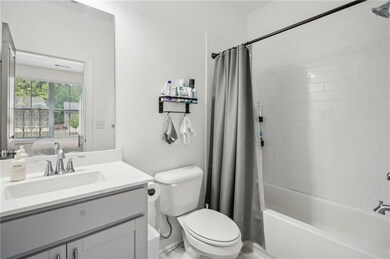 Bathroom with shower / tub combo with curtain, toi