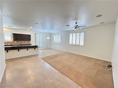 Unfurnished living room with visible vents, basebo