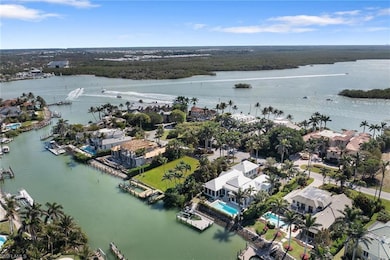 Aerial perspective of suburban area featuring a nearby body of water