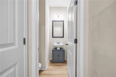 Bathroom featuring a sink, wood finished floors, a