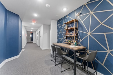 A contemporary hallway entrance to the elevator wi