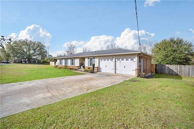 Ranch-style house featuring fence, concrete drivew
