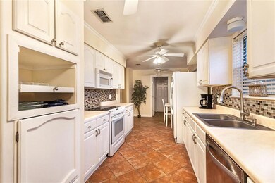 Galley style kitchen with tile floor