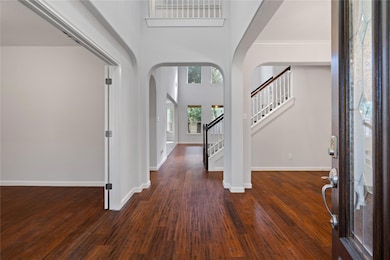 Entrance foyer featuring arched walkways, a tower