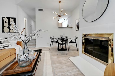 Living room with baseboards, light wood-type floo