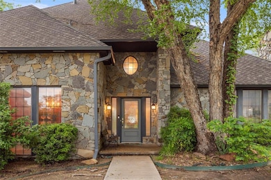 Property entrance featuring a shingled roof and st