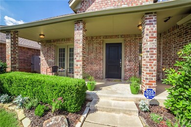 Wide covered front porch with French doors leading