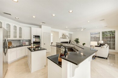 A sleek, modern kitchen with white cabinets and bl