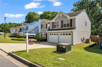 Traditional-style house with driveway, a garage, a