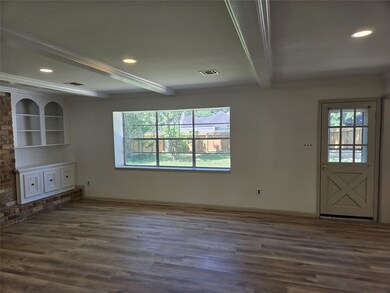 Bright living room with large window, wood floorin