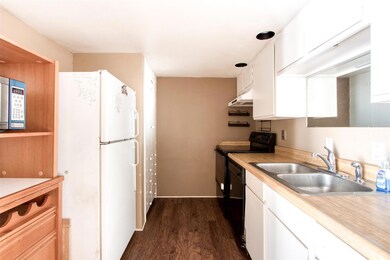 Kitchen with white cabinets, white refrigerator, d