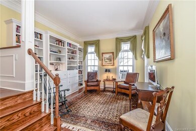 Library with built-in shelves and large windows.