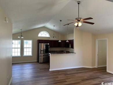 Kitchen with stainless steel fridge, a ceiling fan