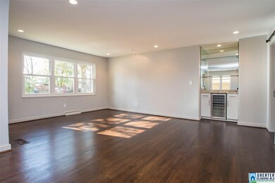 Open floor plan in living/dining  area with wine b