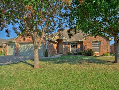 Ranch-style house with driveway, brick siding, a front lawn, and a garage