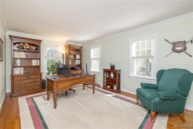 Hardwood floored living room with crown molding