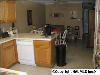 VIEW OF KITCHEN/DINING ROOM WITH PANTRY AND BUILT-IN DESK.