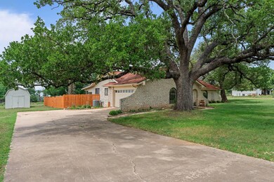 View of front of house with central AC, fence, st