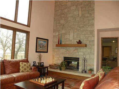 Vaulted ceilings and stone two-way fireplace in fo