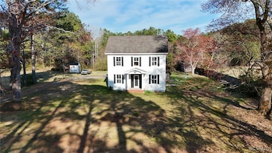 Colonial-style house with a front lawn