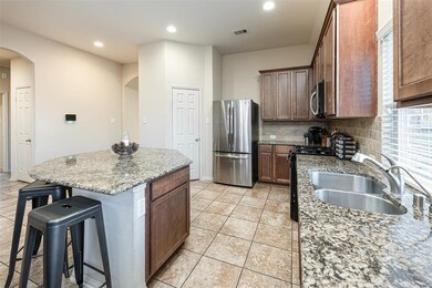 Host the next dinner party with confidence! This masterfully-equipped kitchen features a beautiful kitchen island and breakfast bar, and an abundance of cabinet and counter space!