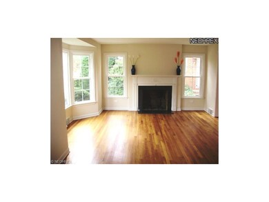 Living room has a large bay window which provides 