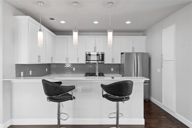 Kitchen with a kitchen bar, stainless steel applia