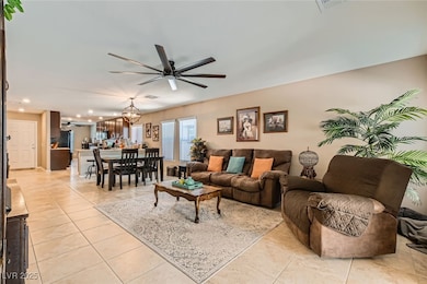 Living area with a ceiling fan, light tile pattern