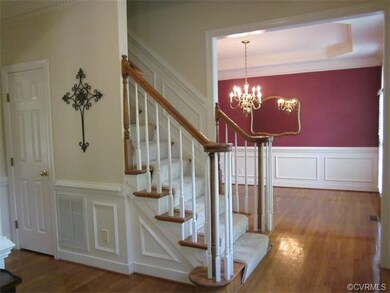 Foyer w/ hardwood floors, hall closet & half bath.