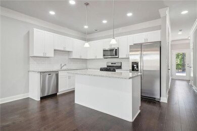 Kitchen with white cabinetry, dishwasher, pendant 
