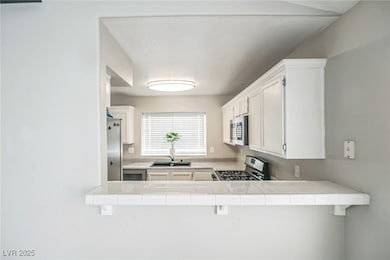 Kitchen featuring stainless steel appliances, tile