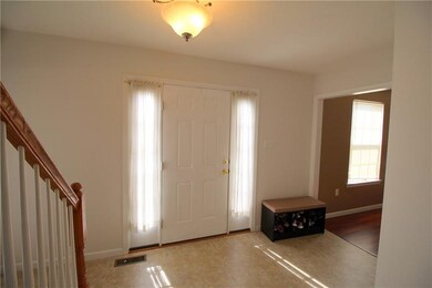 Foyer entry with open staircase to dining room.  T