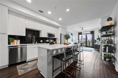 Kitchen with white cabinetry, wood-type flooring, 