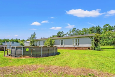 Back of property featuring crawl space and a lawn