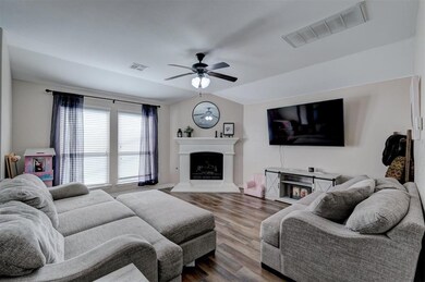 Living room with ceiling fan, wood-style flooring,