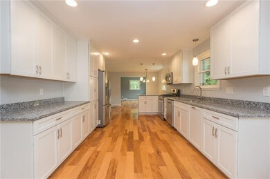 Gorgeous custom kitchen complete with hickory floo