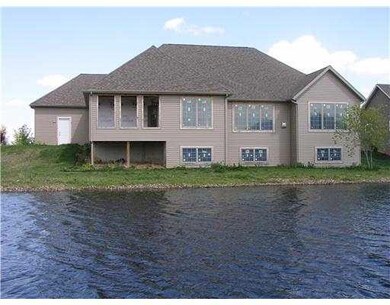 VIEW OF REAR SIDE OF HOME FROM ACROSS THE POND