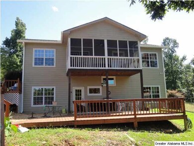 Rear of home with screened porch and open deck fac