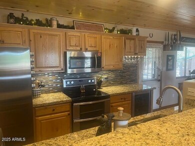 kitchen w granite and wine fridge