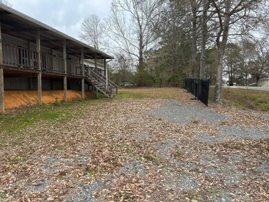 View of yard with a wooden deck and metal fencing