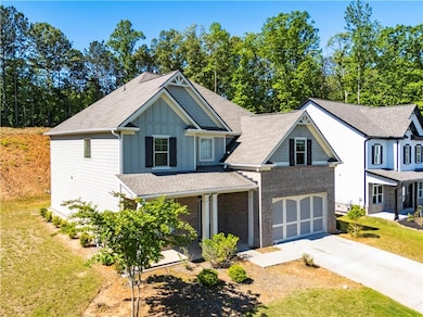 View of front facade with concrete driveway, board