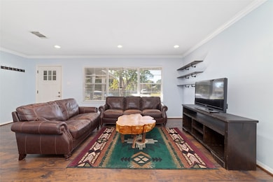 Bright and inviting living space with large windows and open flow into the dining and kitchen areas.