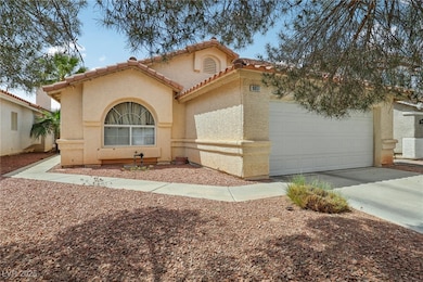 Mediterranean / spanish-style home with an attache