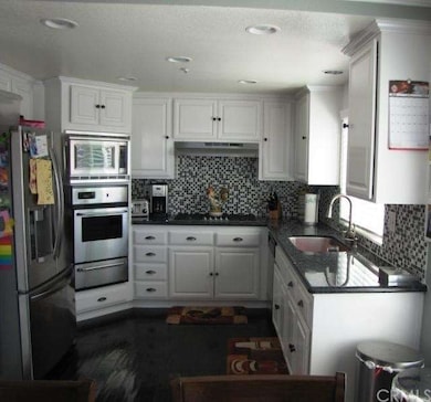 Kitchen with granite counters, glass tiled backspl