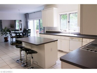 Spacious Eat-in Kitchen with White Cabinets, Cente