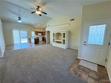 Unfurnished living room featuring vaulted ceiling,