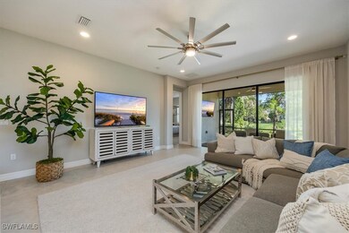 Living room featuring a ceiling fan, tile patterne