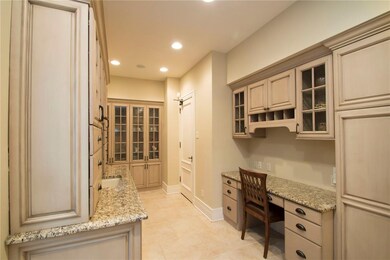 Butler Pantry featuring desk, sink prep area, and two coolers.