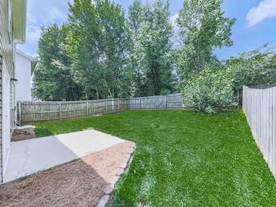 Fenced backyard with a patio